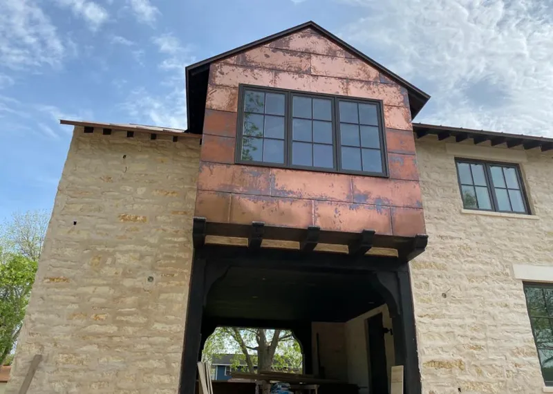 Copper metal panel facade on a stone building for Roof Repair in Coalinga